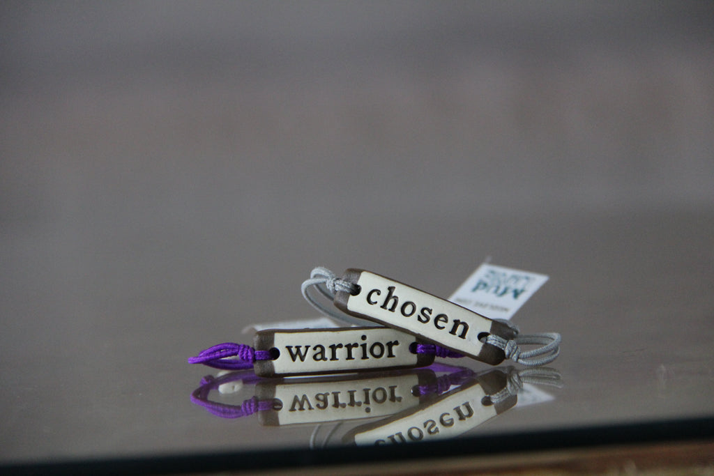 Decorative keychains with motivational phrases on a reflective surface
