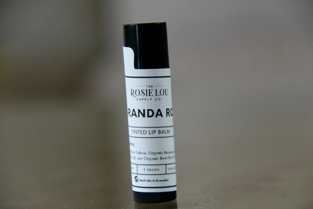 Lip balm tube with label on a blurred background